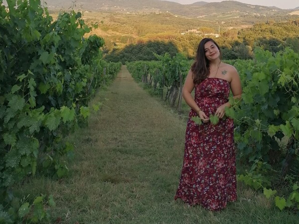 a woman standing in front of a mountain