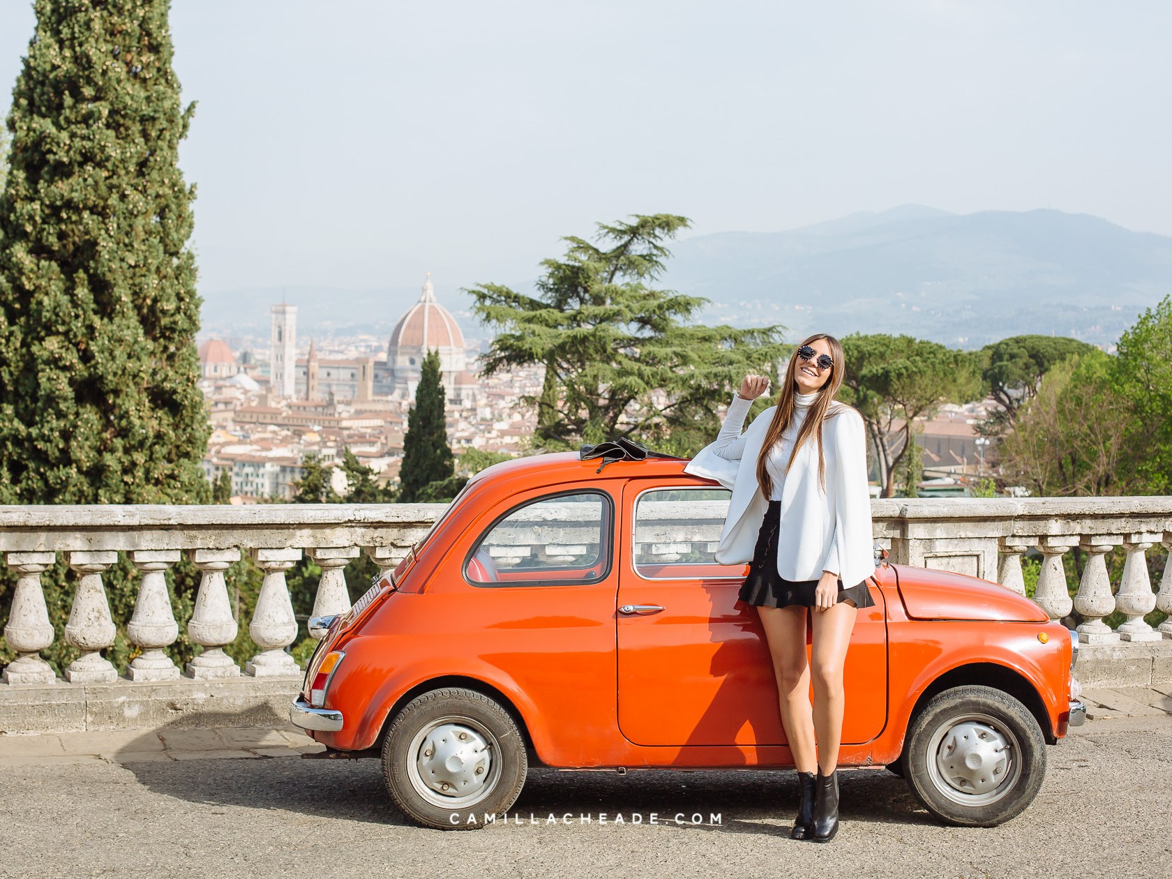 a person standing in front of a car