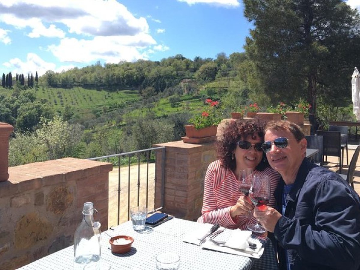 a man and a woman sitting at a table with wine glasses