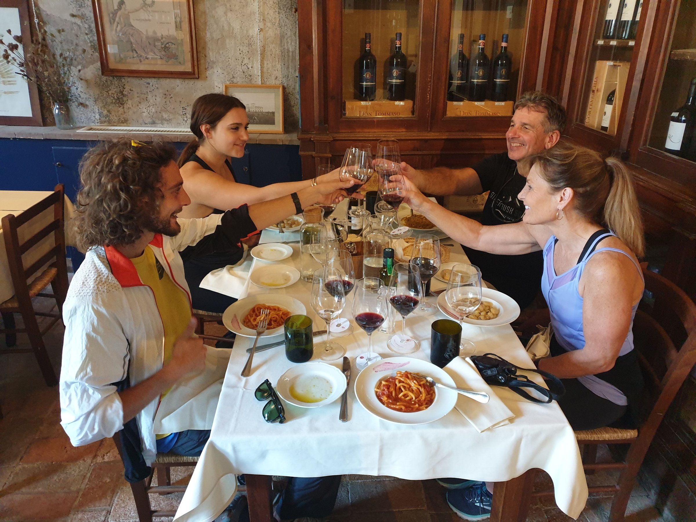 a group of people sitting at a table eating food
