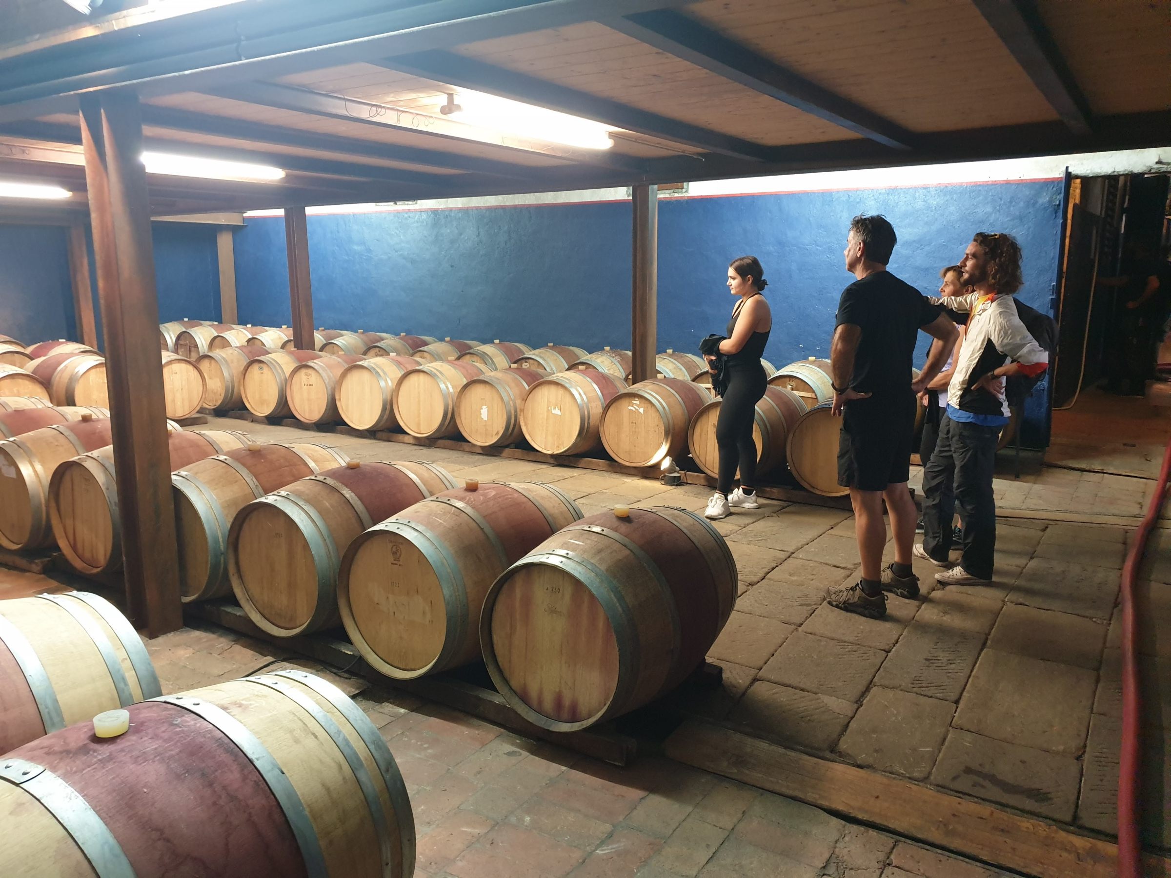 a group of people standing in front of a barrel