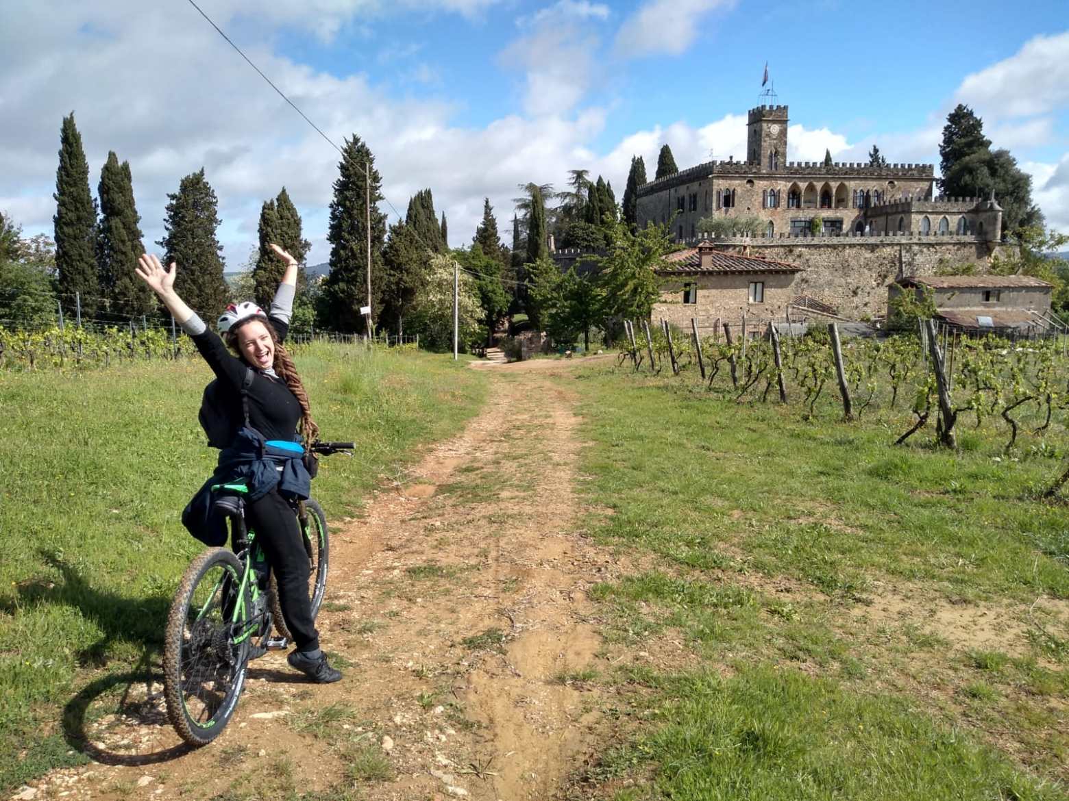 a person riding a bike down a dirt road