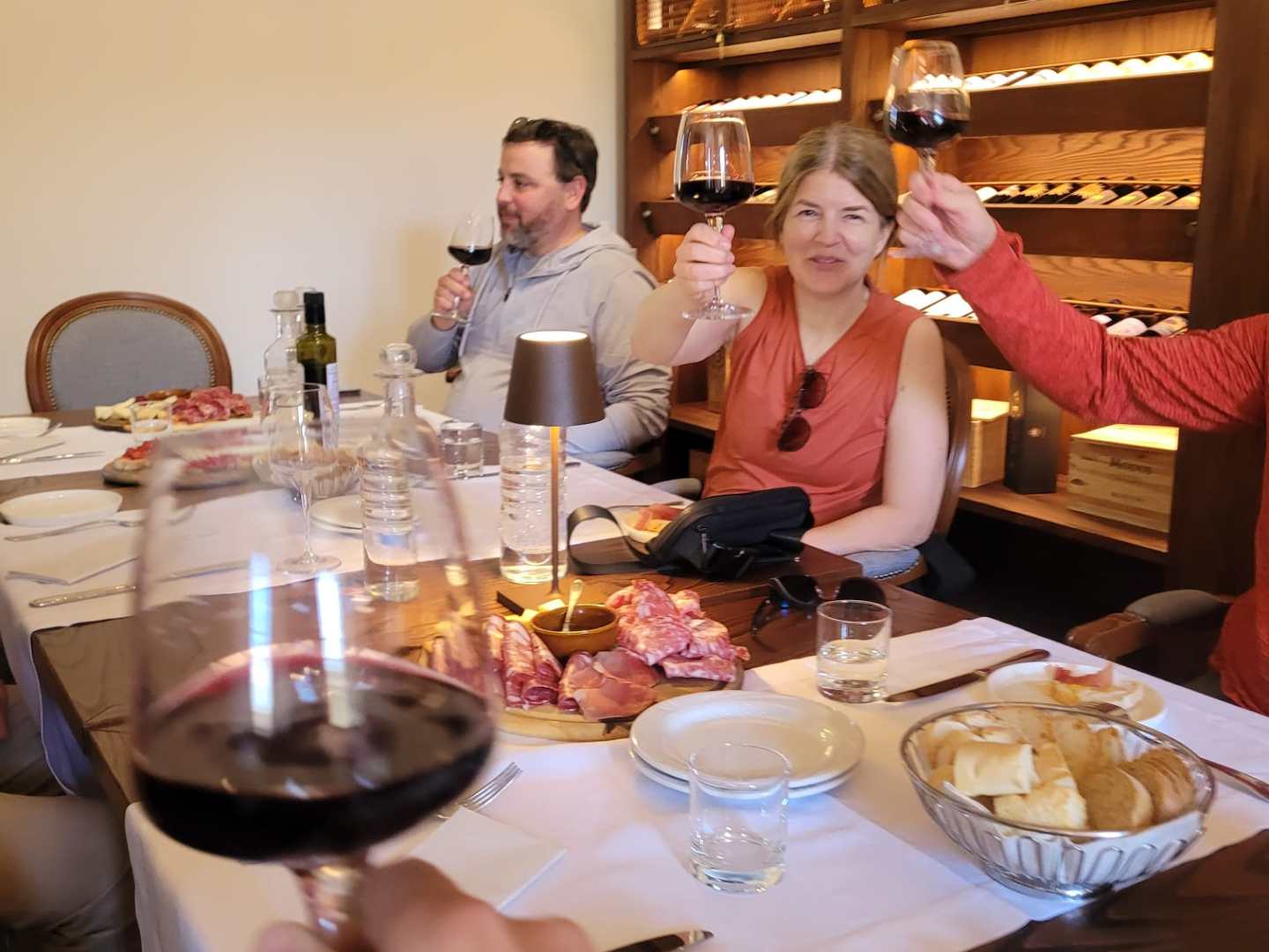 a group of people sitting at a table with a plate of food