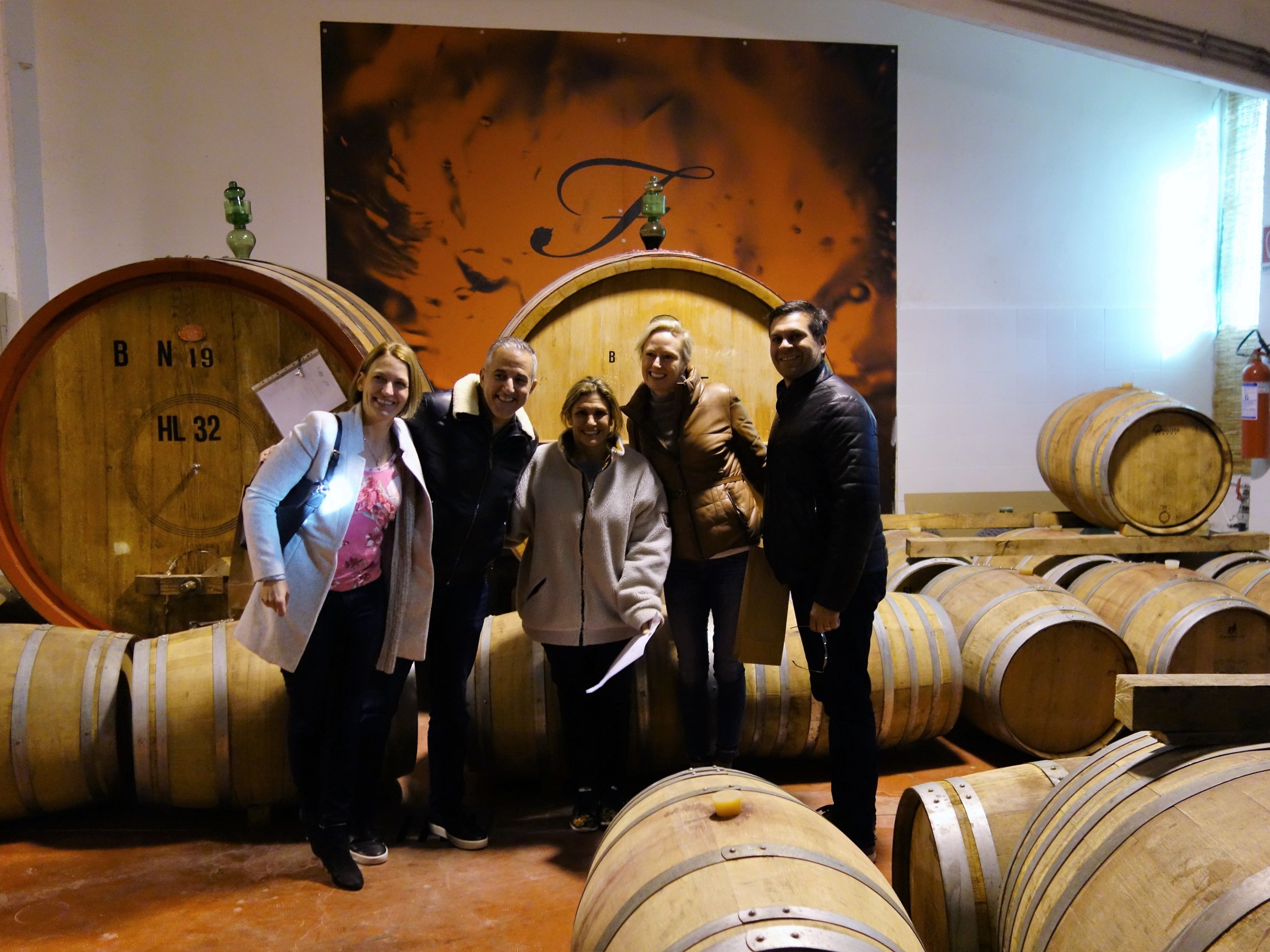 People among wine barrels in San Gimignano