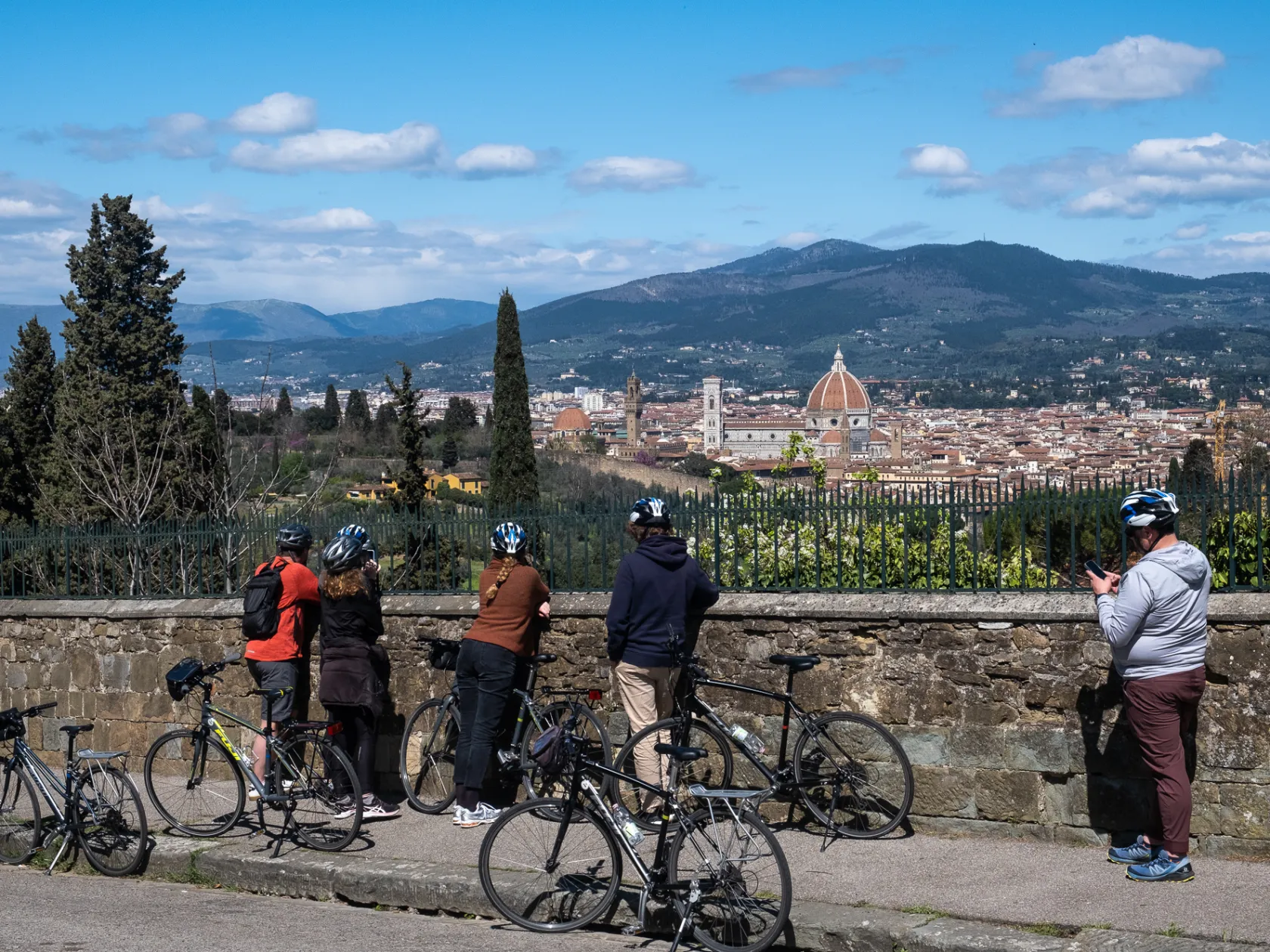 a group of people riding on the back of a bicycle