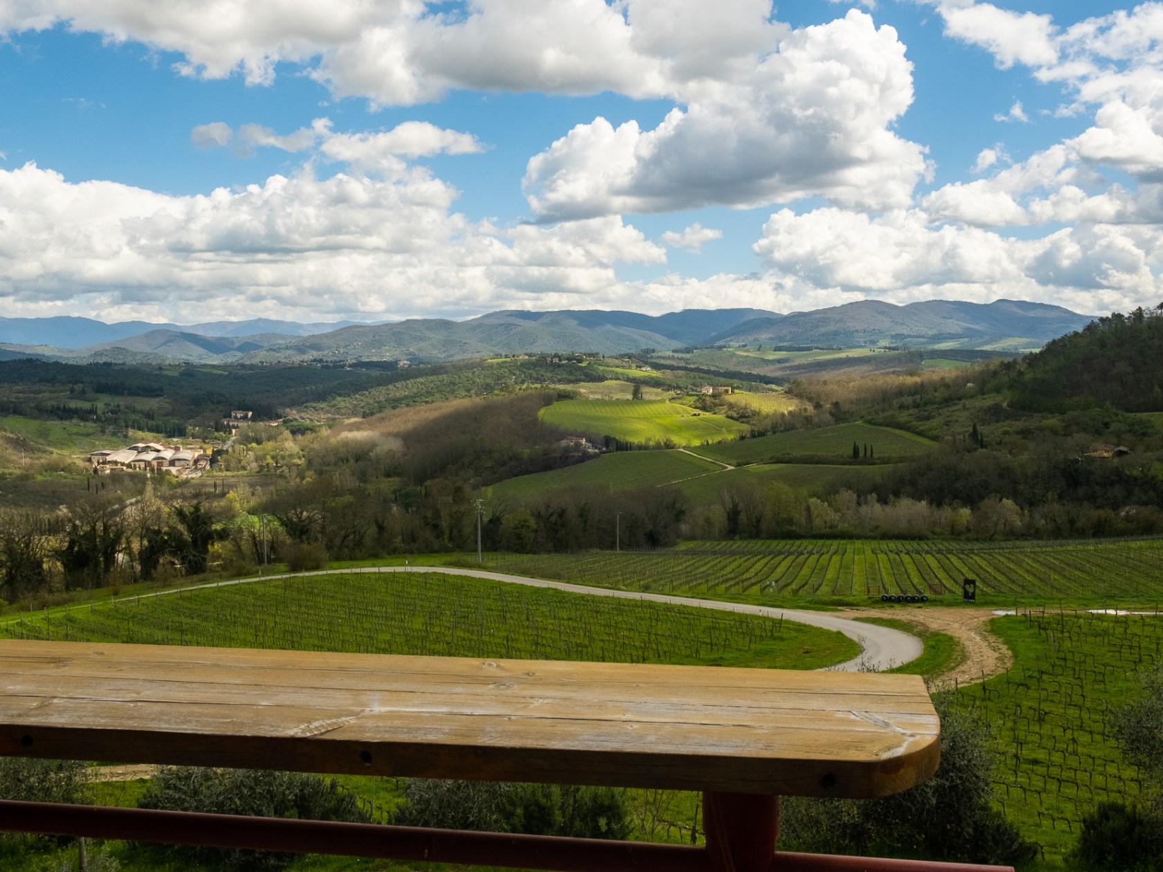 a wooden bench sitting on top of a lush green field