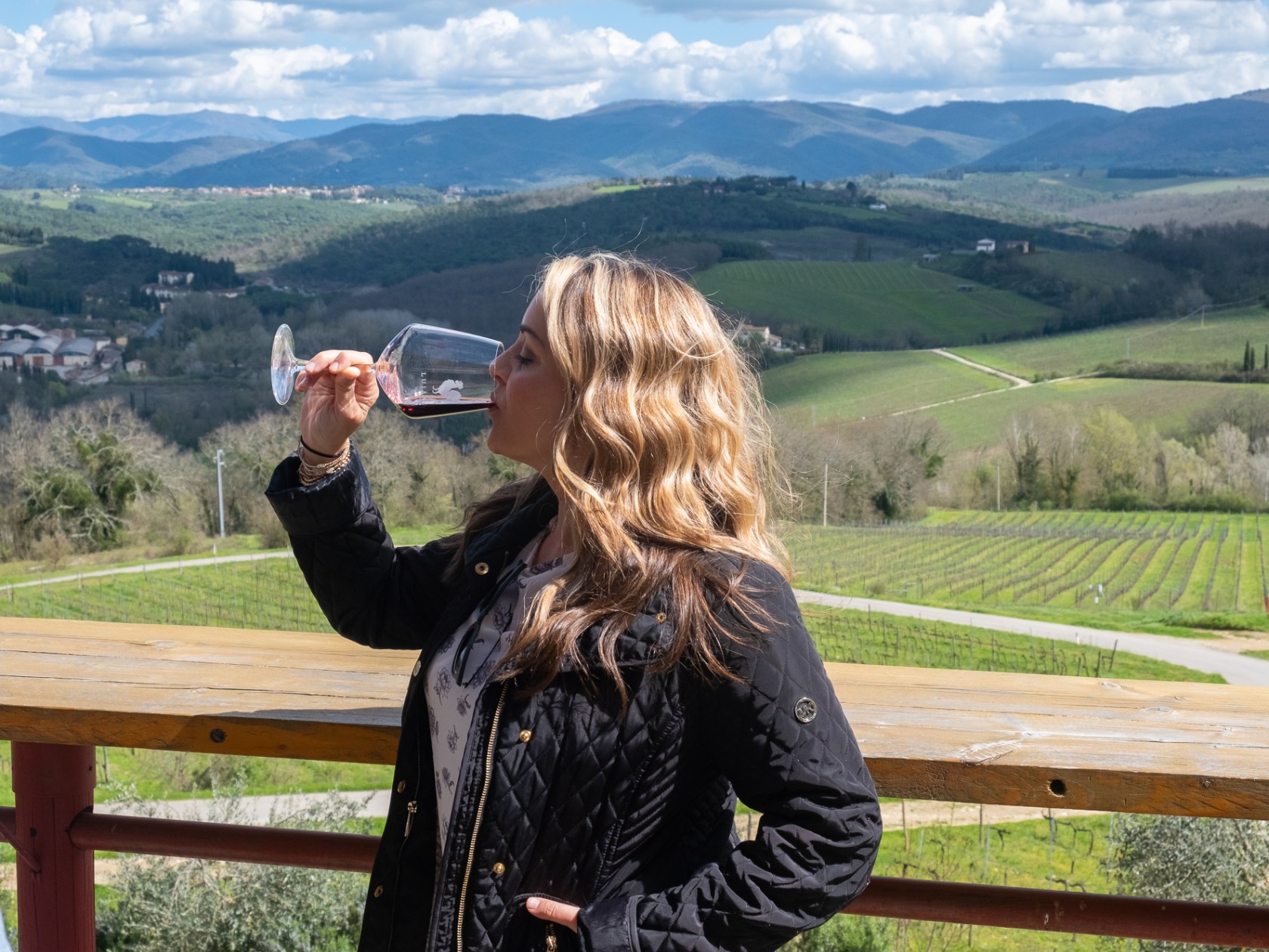 a person sitting on a bench in front of a mountain