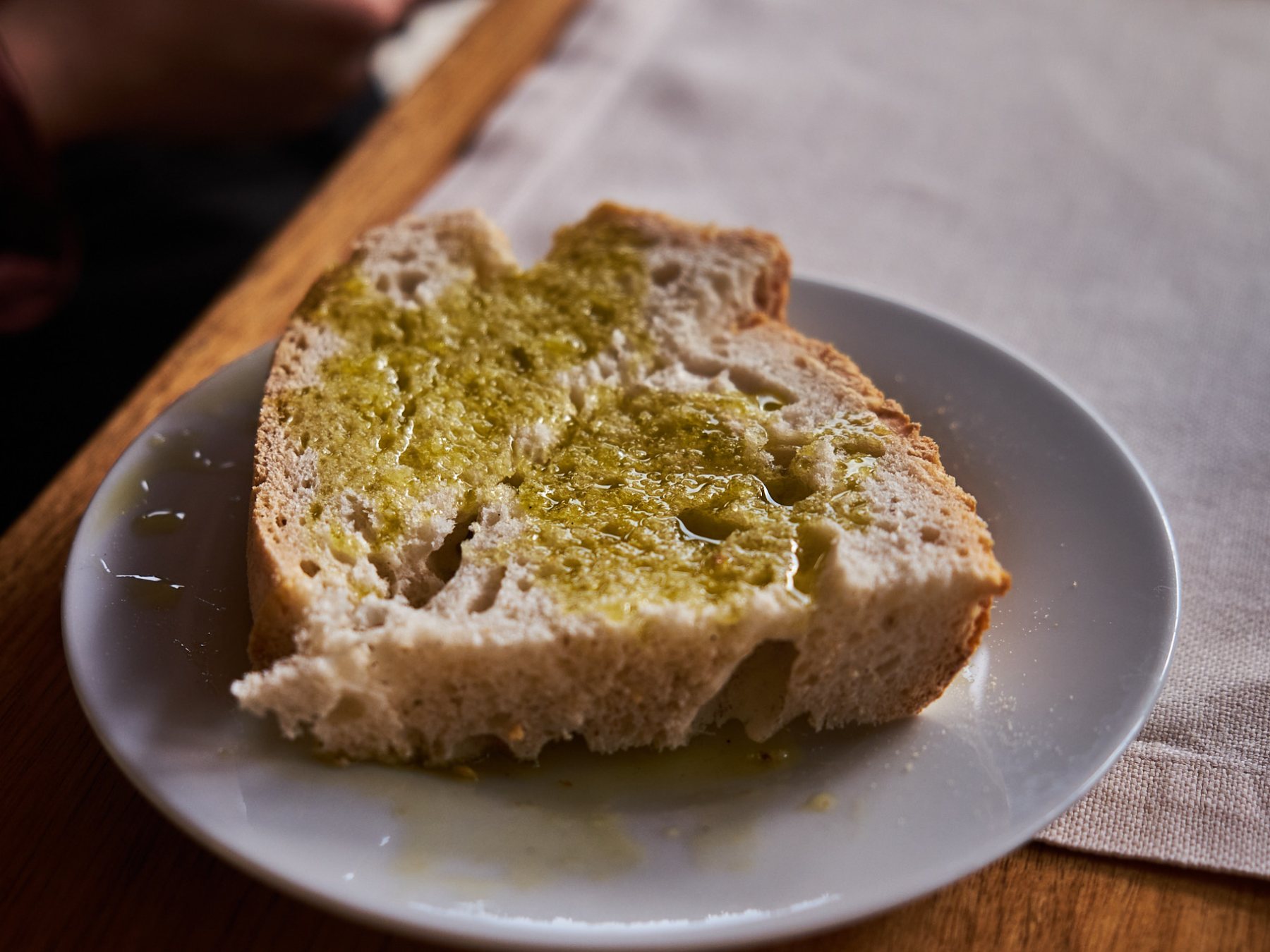 a piece of bread with extra virgin olive oil