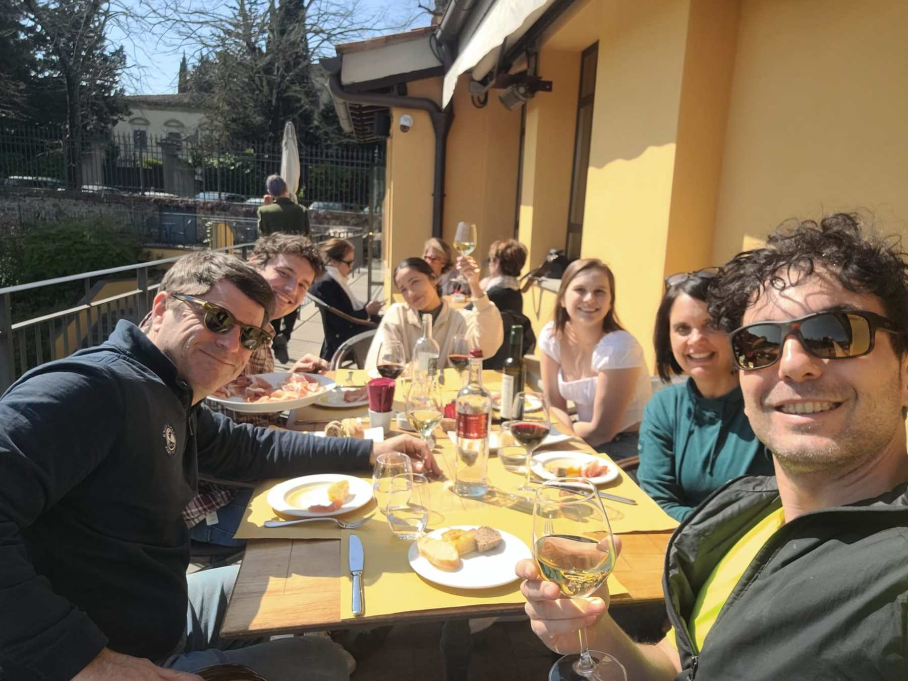 a group of people sitting at a table eating food