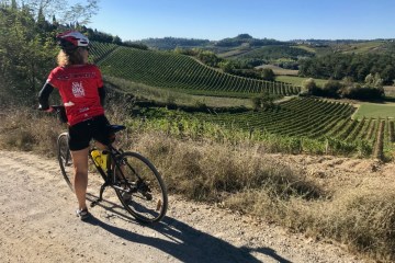 Bike rider in a tuscan field in Francigena trail