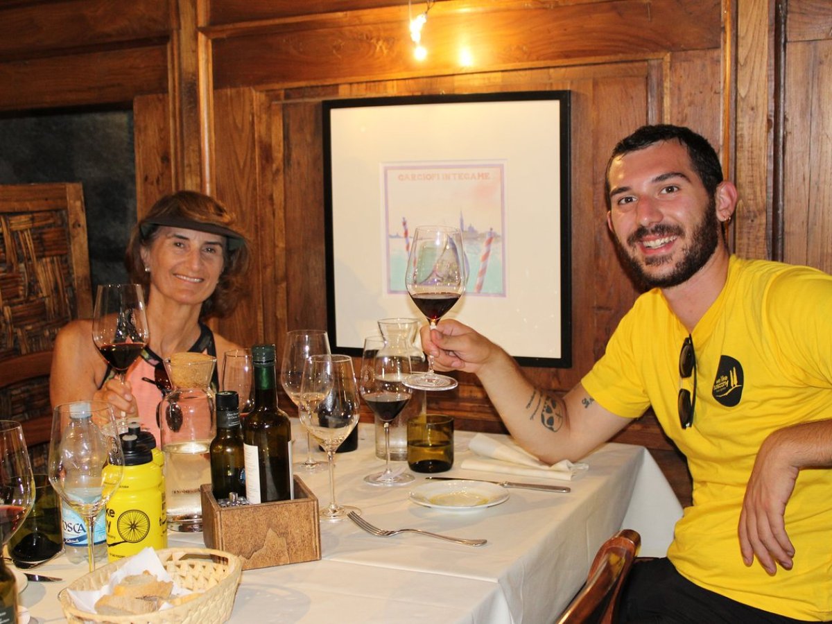 Hazel Dickens et al. sitting at a table with wine glasses