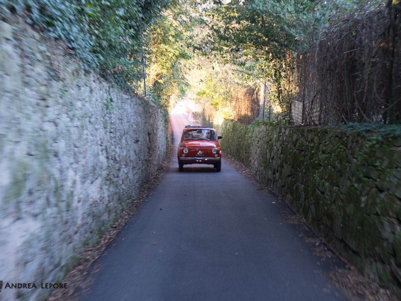 a bus driving down a dirt road