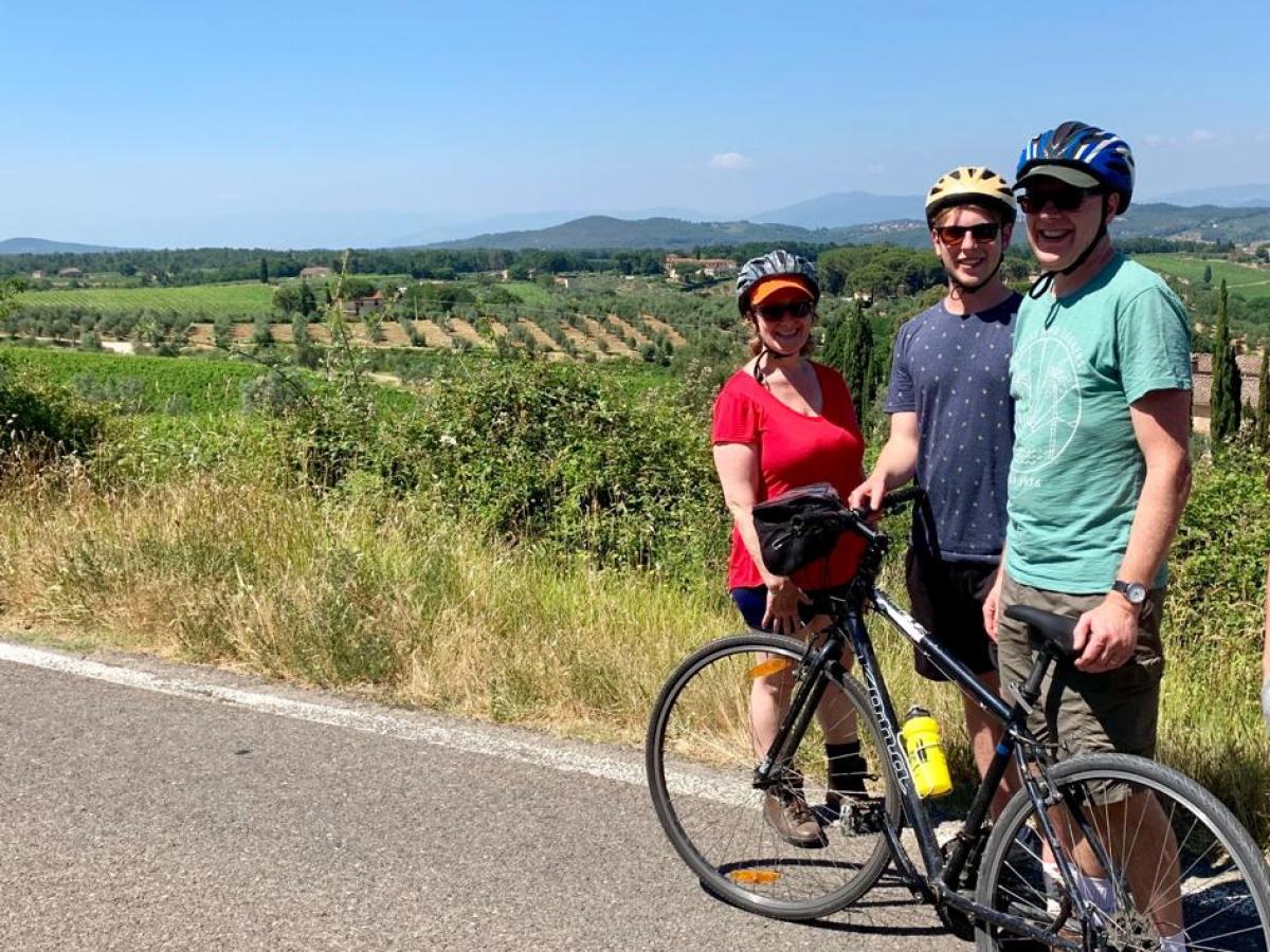 Three people on italian road with bike