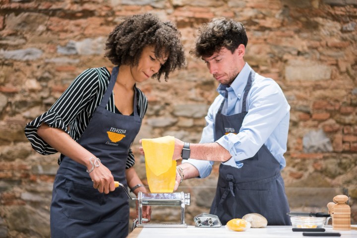 man and woman cooking food in Tuscany