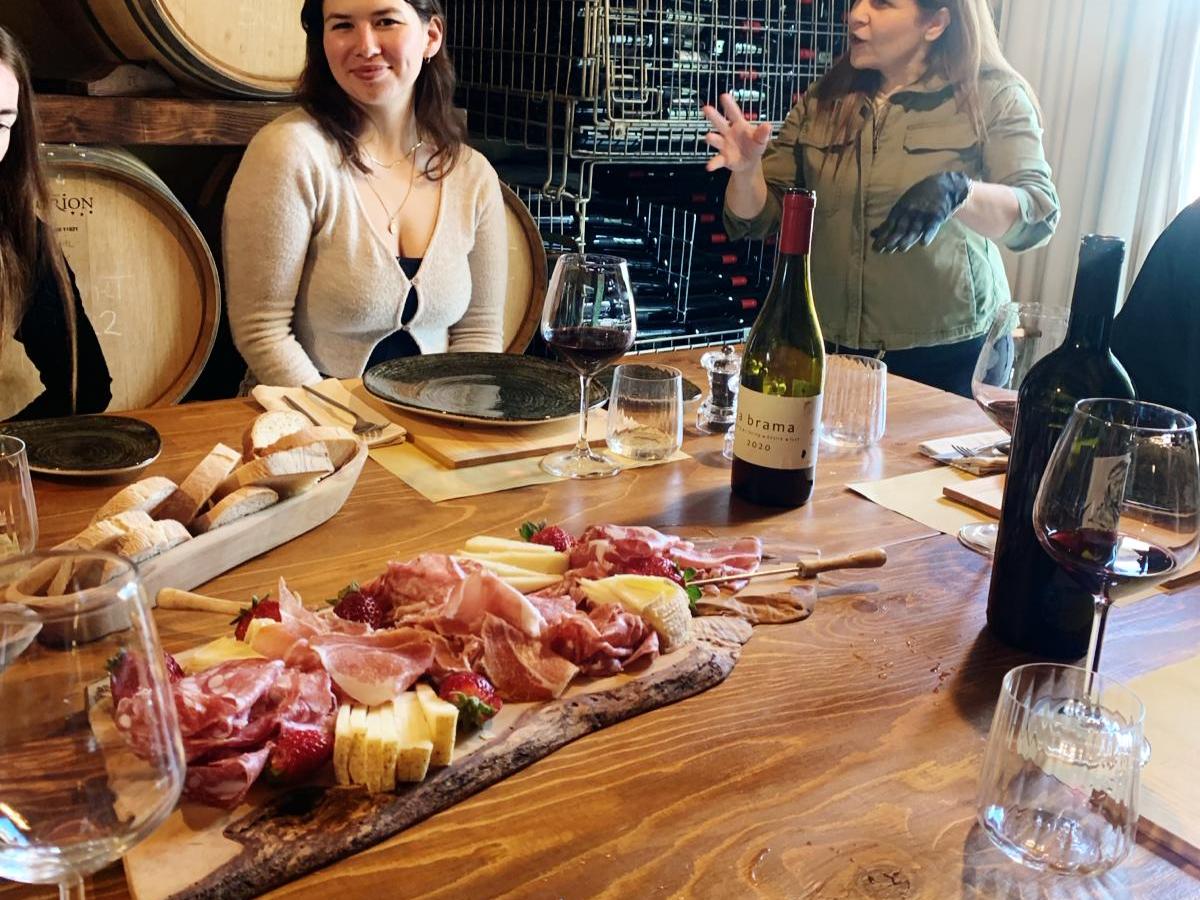 Tracey Ullman et al. sitting at a table with wine glasses
