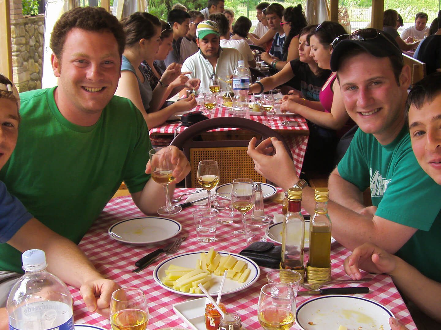 a group of people sitting at a table with a plate of food