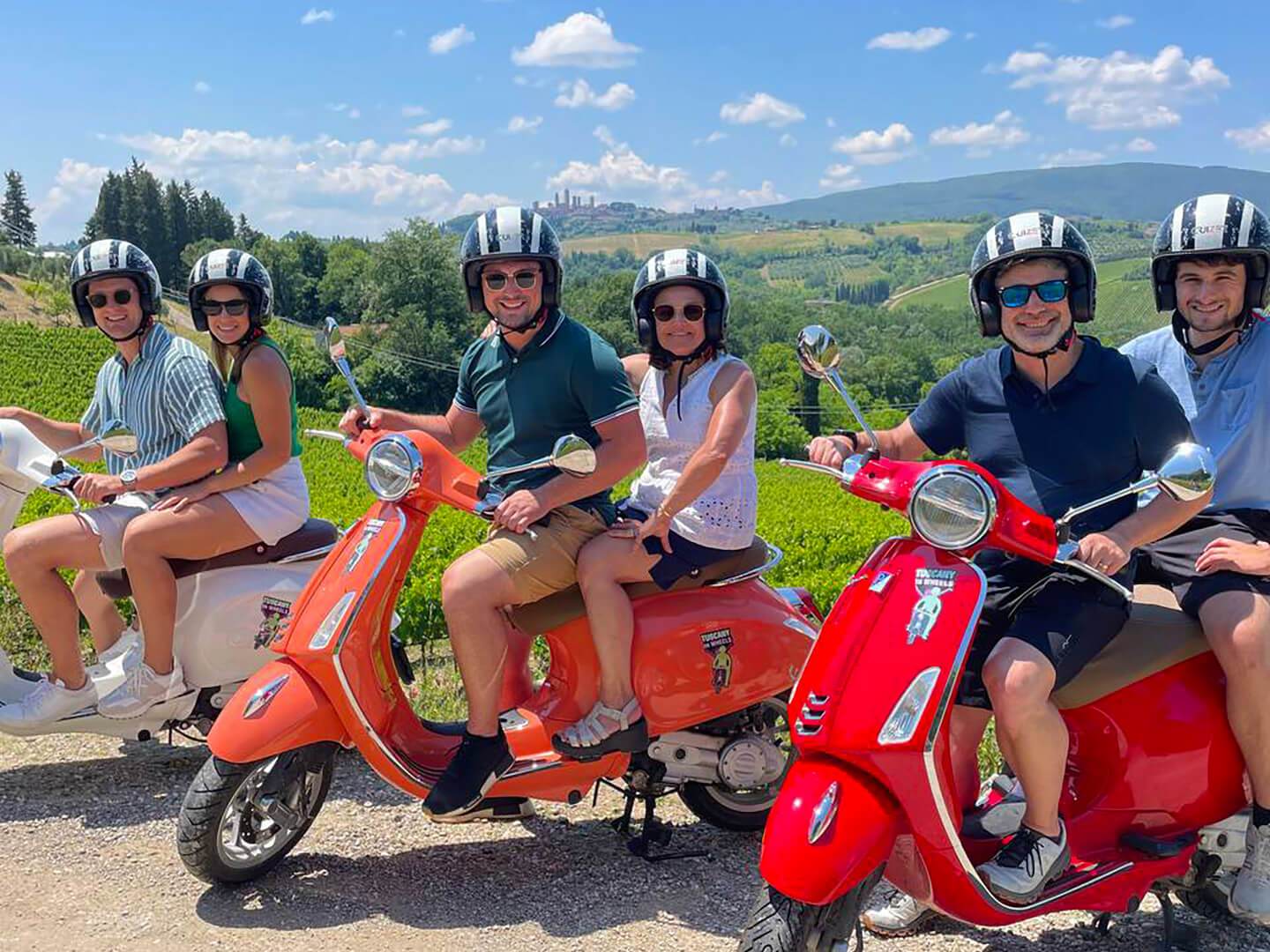 a group of people sitting on a motorcycle