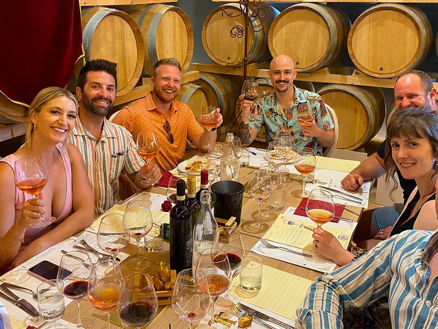 a group of people sitting at a table posing for the camera