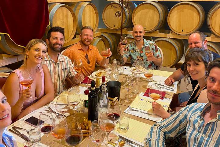 a group of people sitting at a table posing for the camera