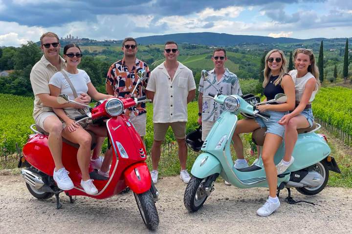 a group of people sitting on a motorcycle