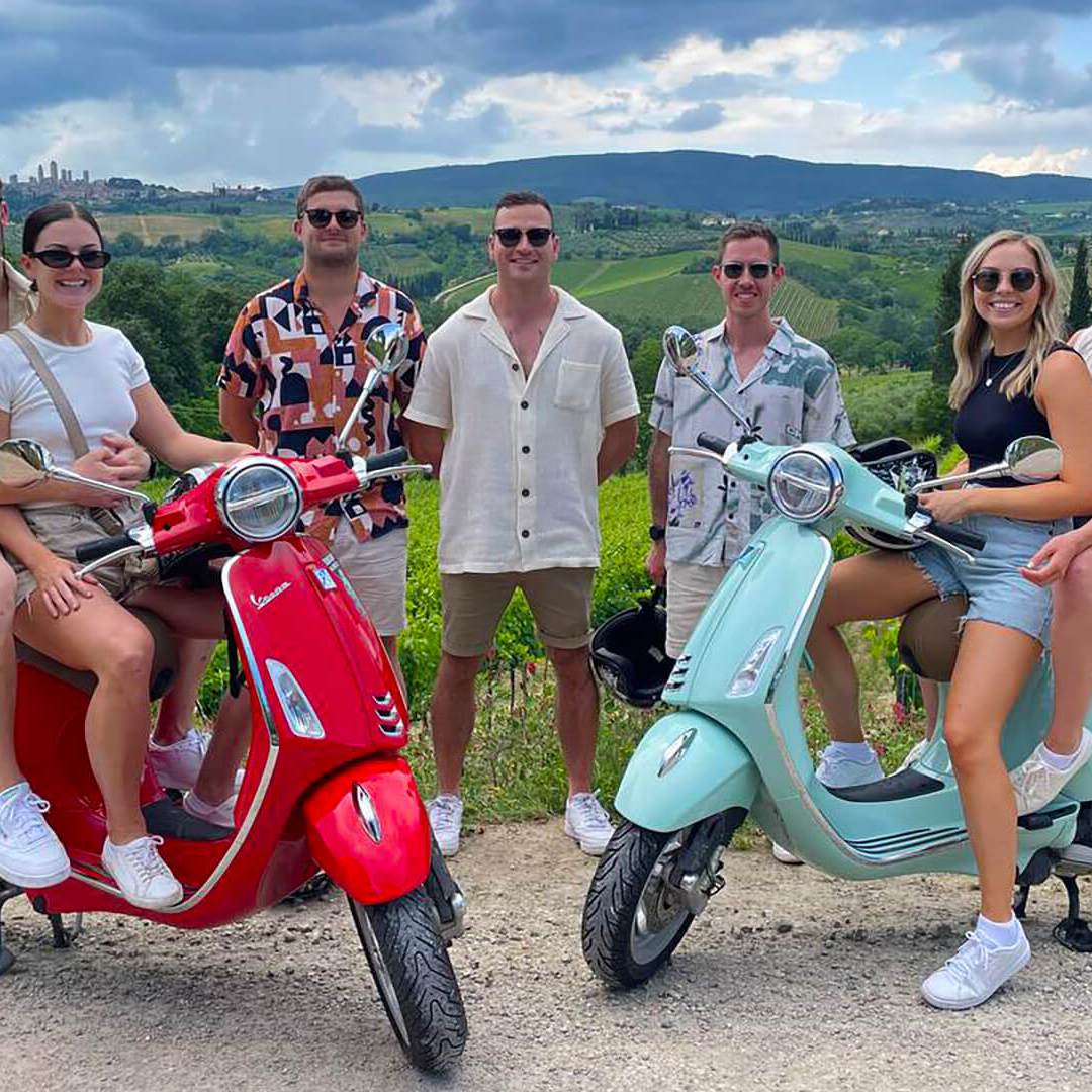 a group of people sitting on a motorcycle