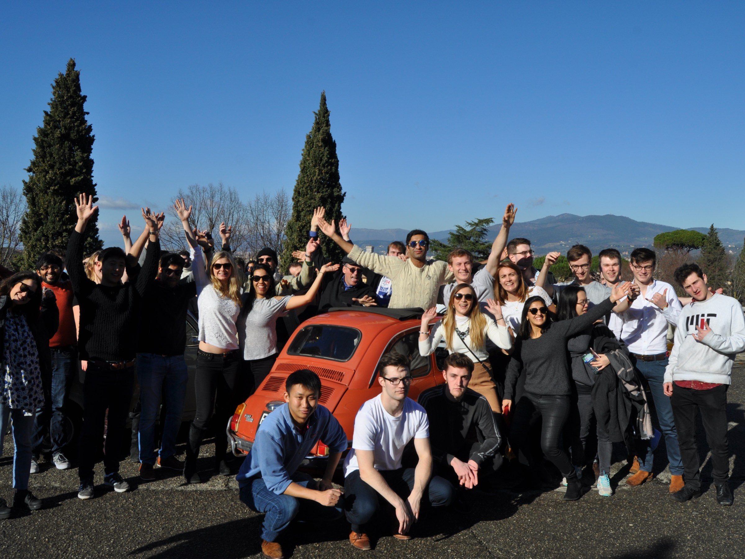 people standing next to fiat 500 car parked in Tuscany
