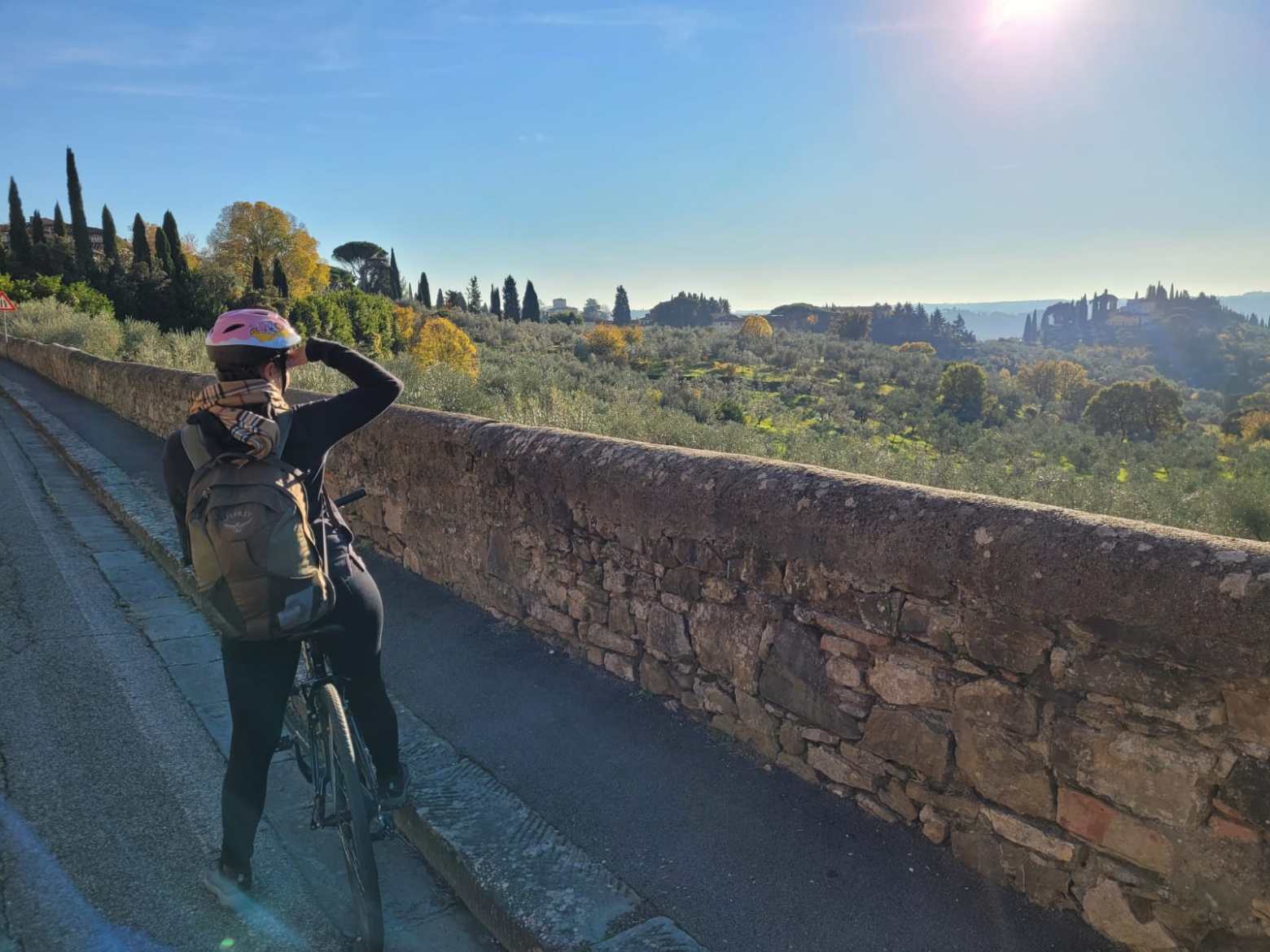 Person on bike taking pictures of tuscan landscape