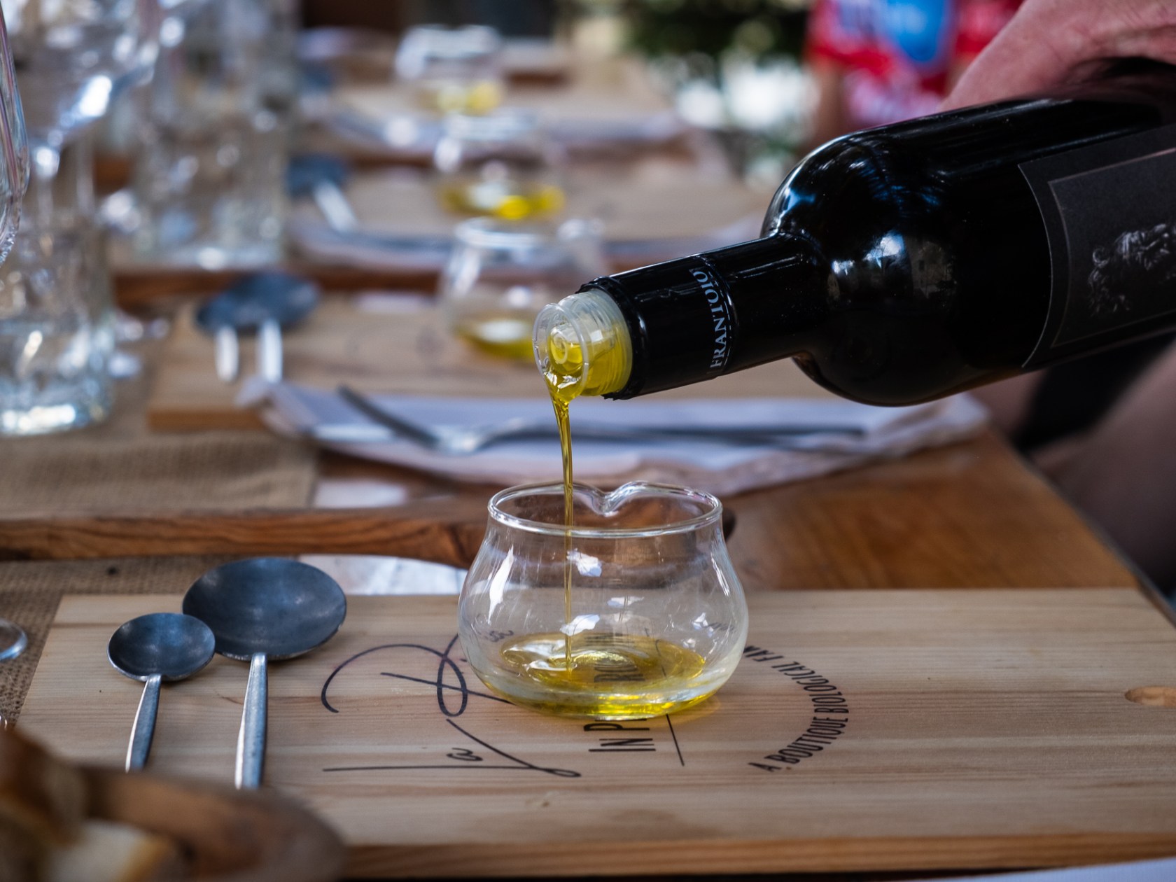 a glass of wine sitting on top of a wooden table