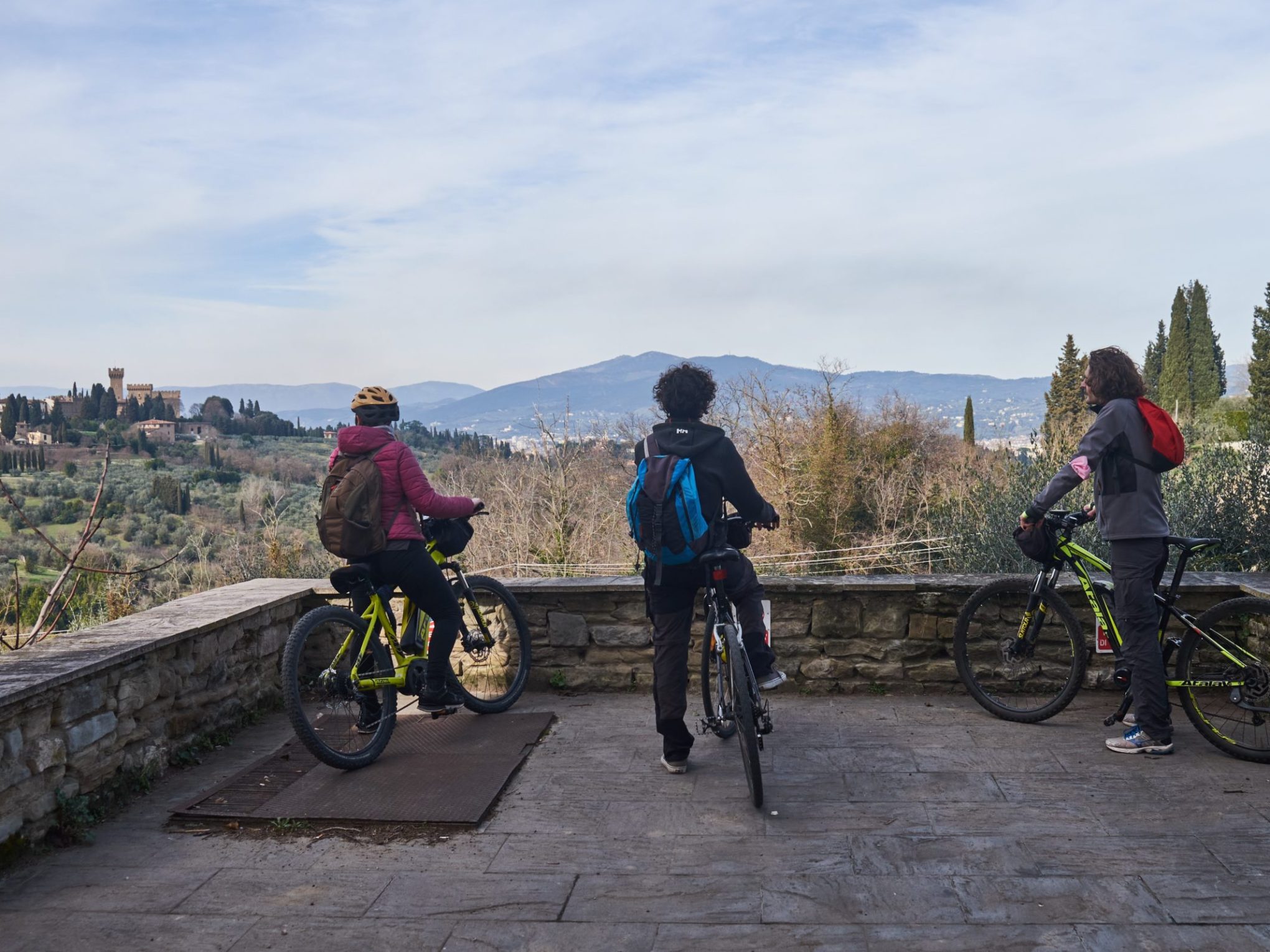a group of people riding on the back of a bicycle