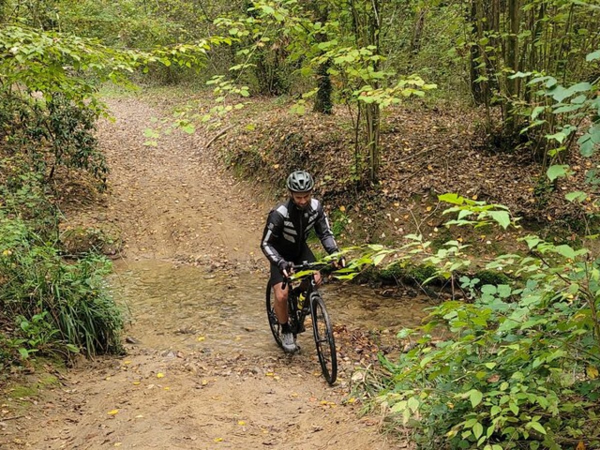 a man riding a bike down a dirt trail