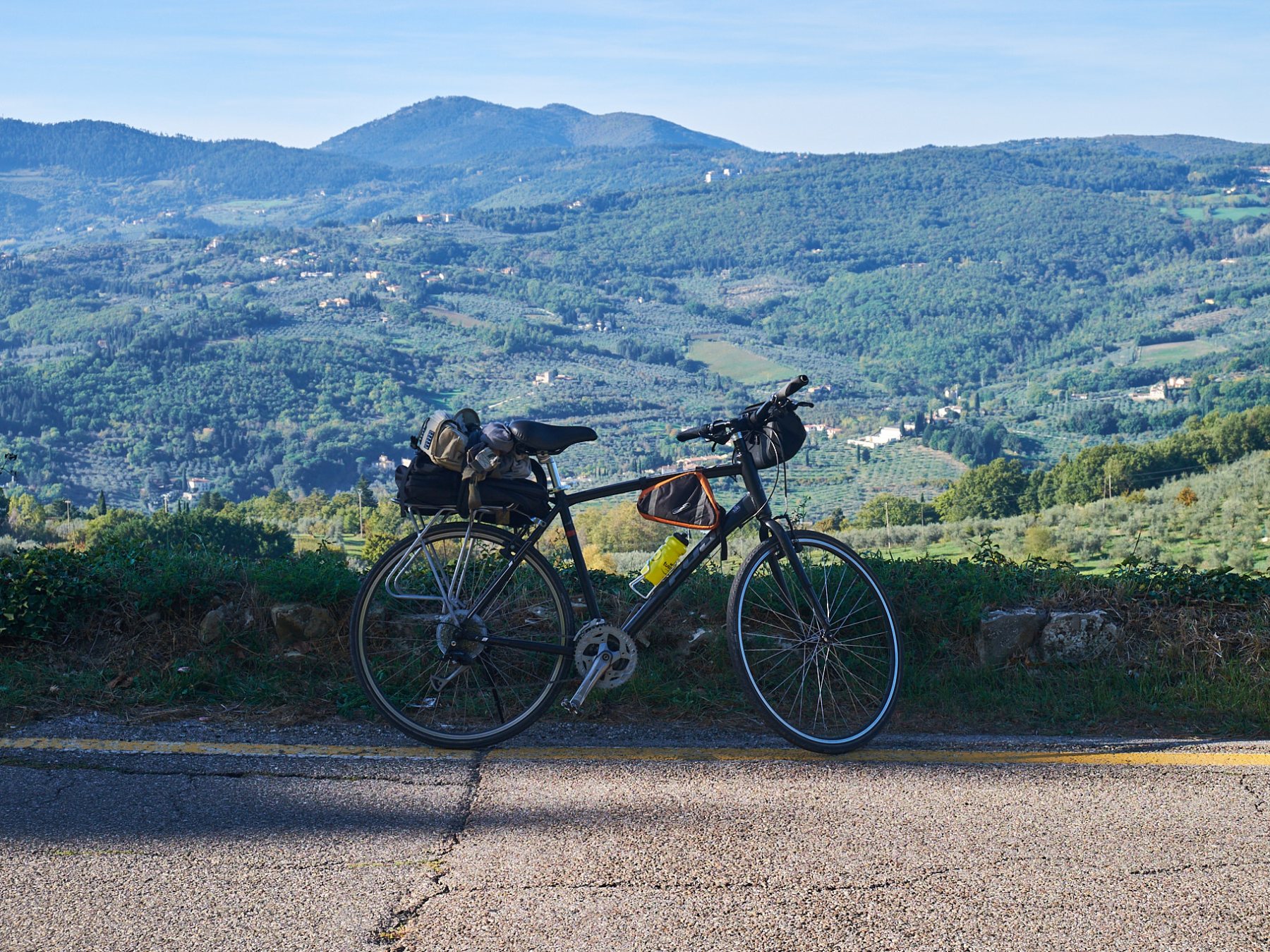 a bicycle parked on the side of a mountain