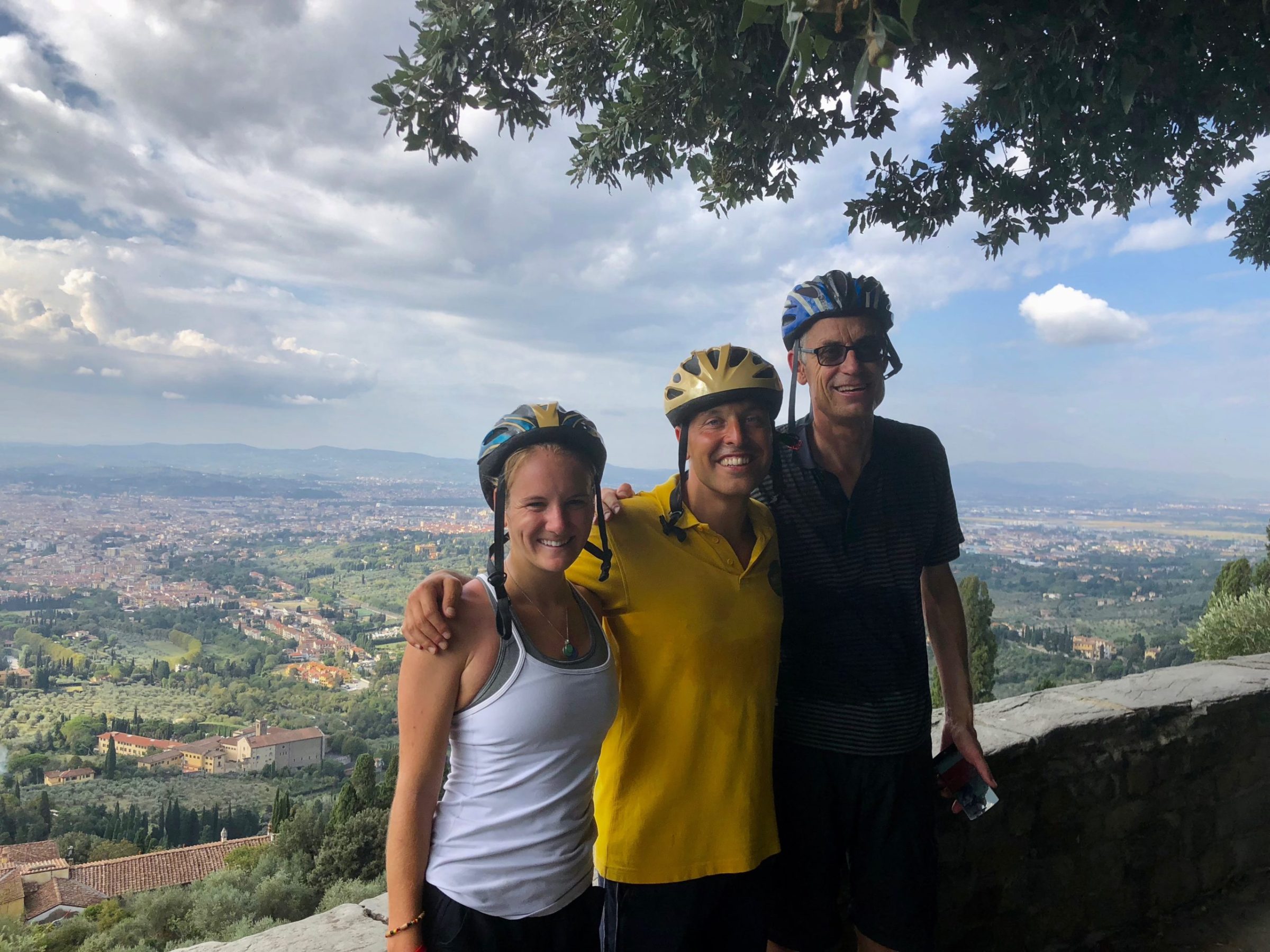 a man and a woman standing in front of a view of an Italian city