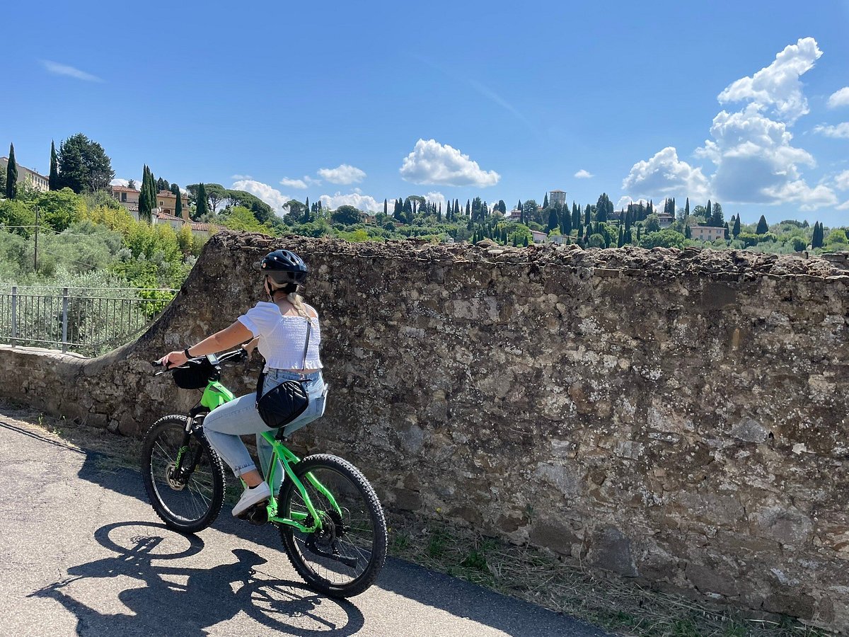 a man riding a bike down a dirt road