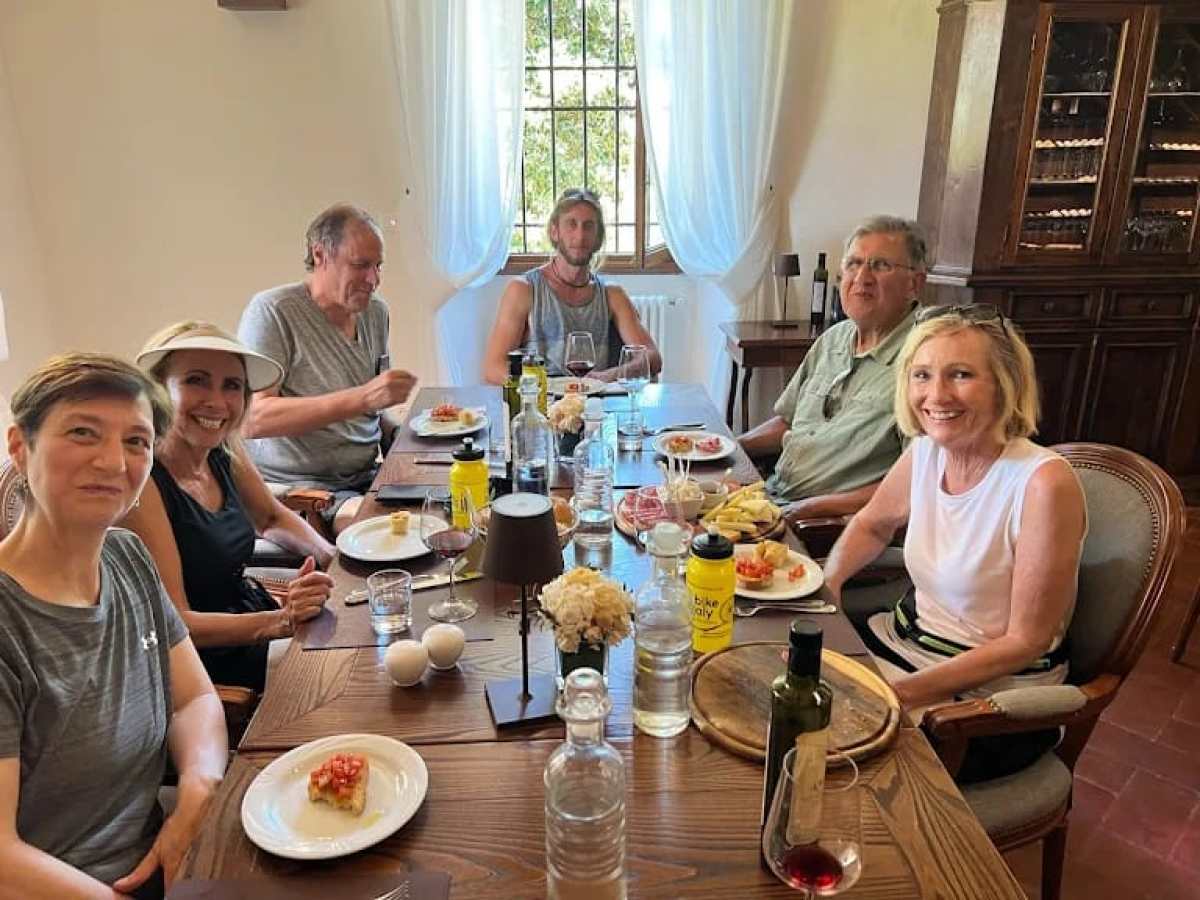 a group of people sitting at a table eating food