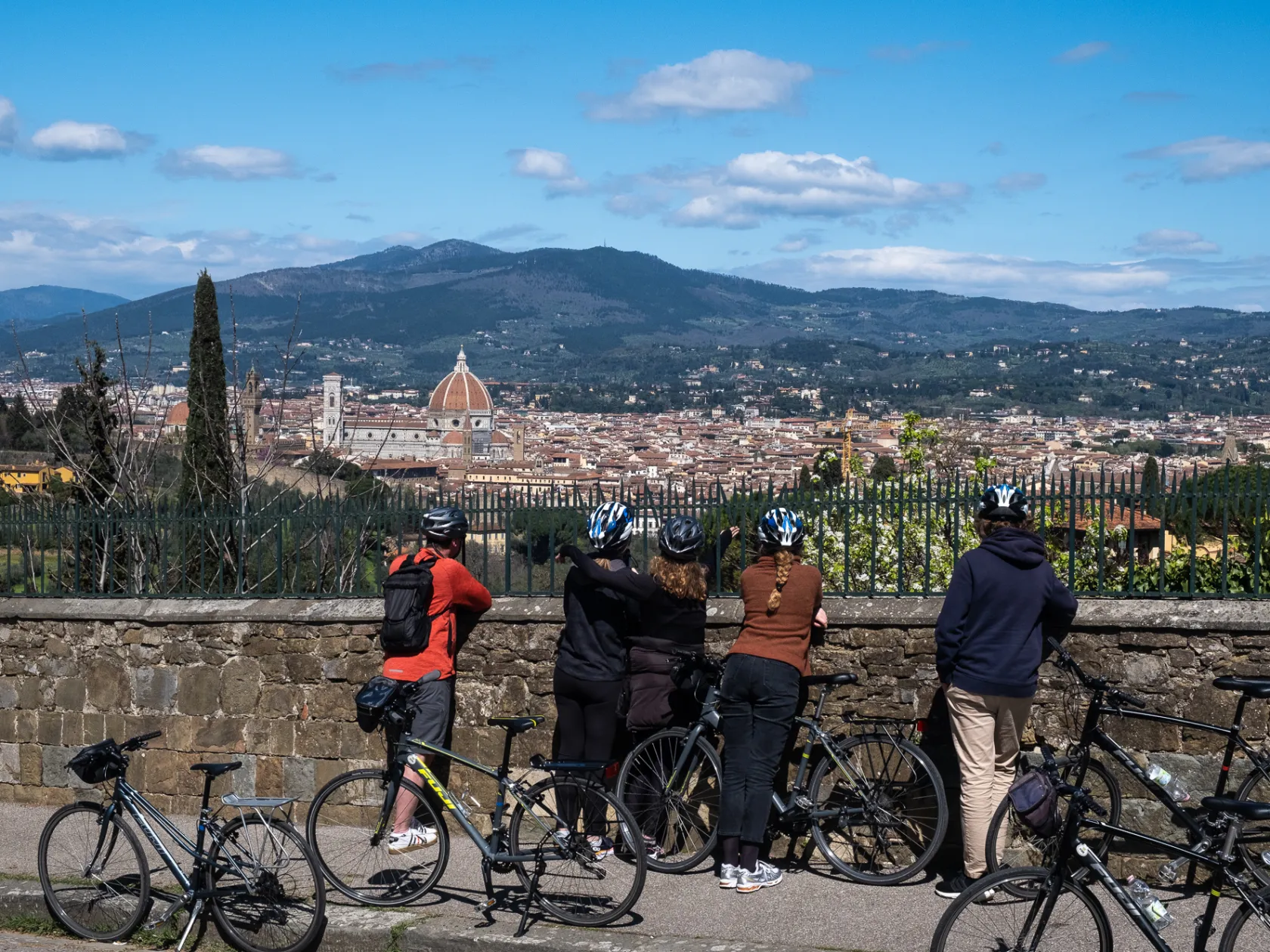 a group of people riding on the back of a bicycle