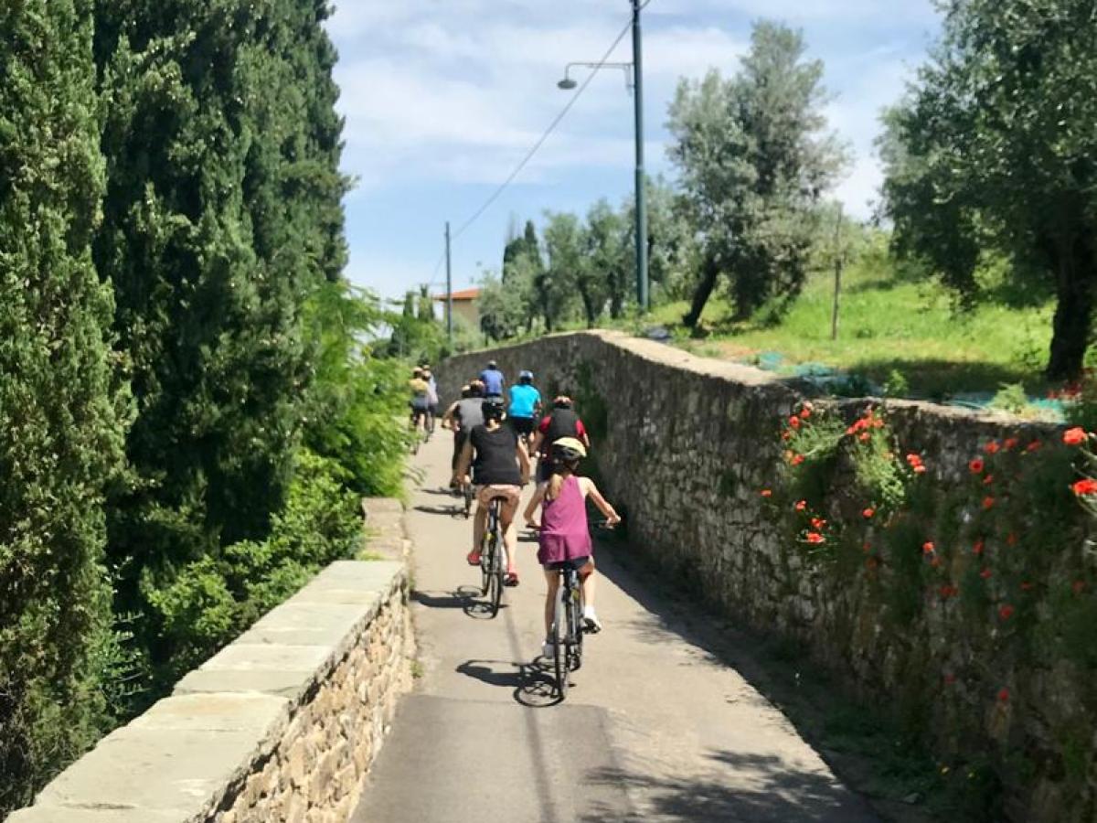 a person riding a bike down a dirt road