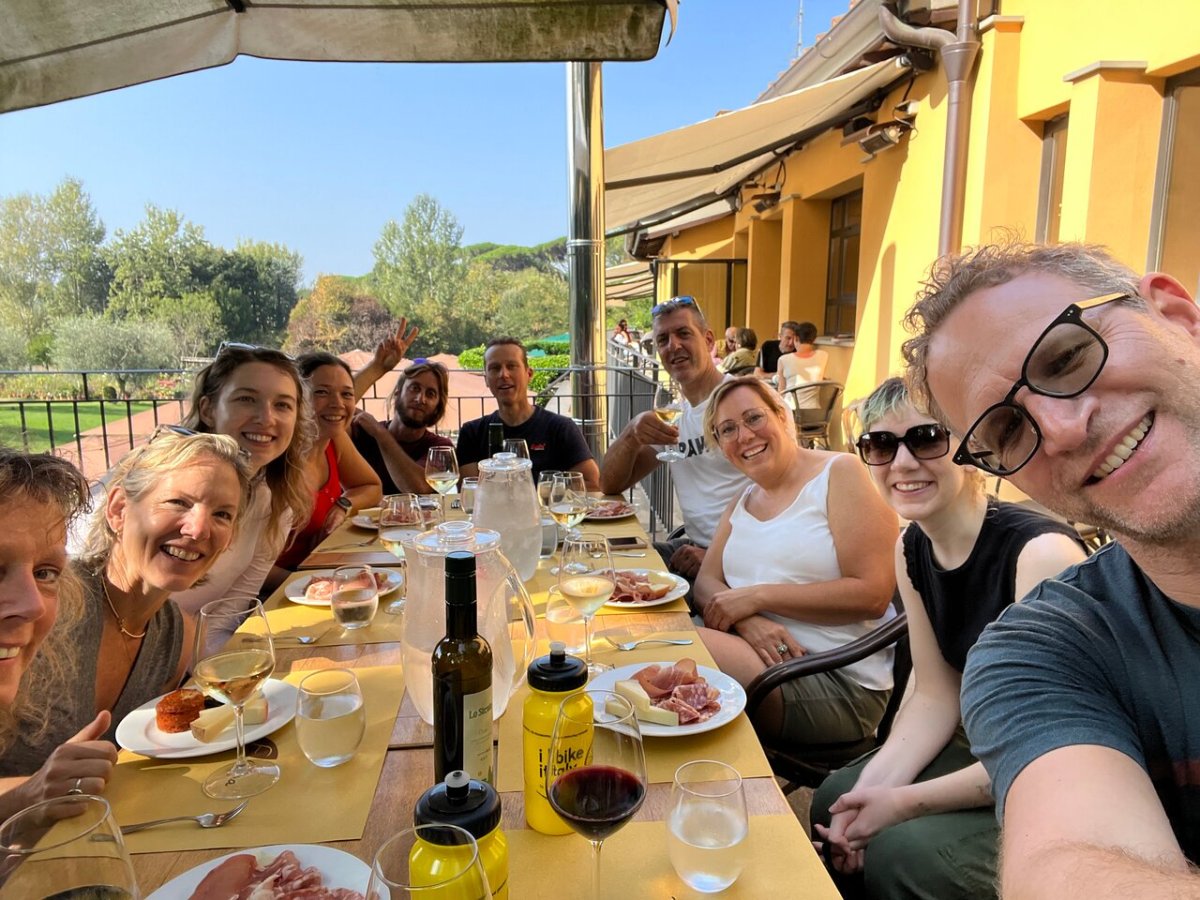 a group of people sitting at a table eating food