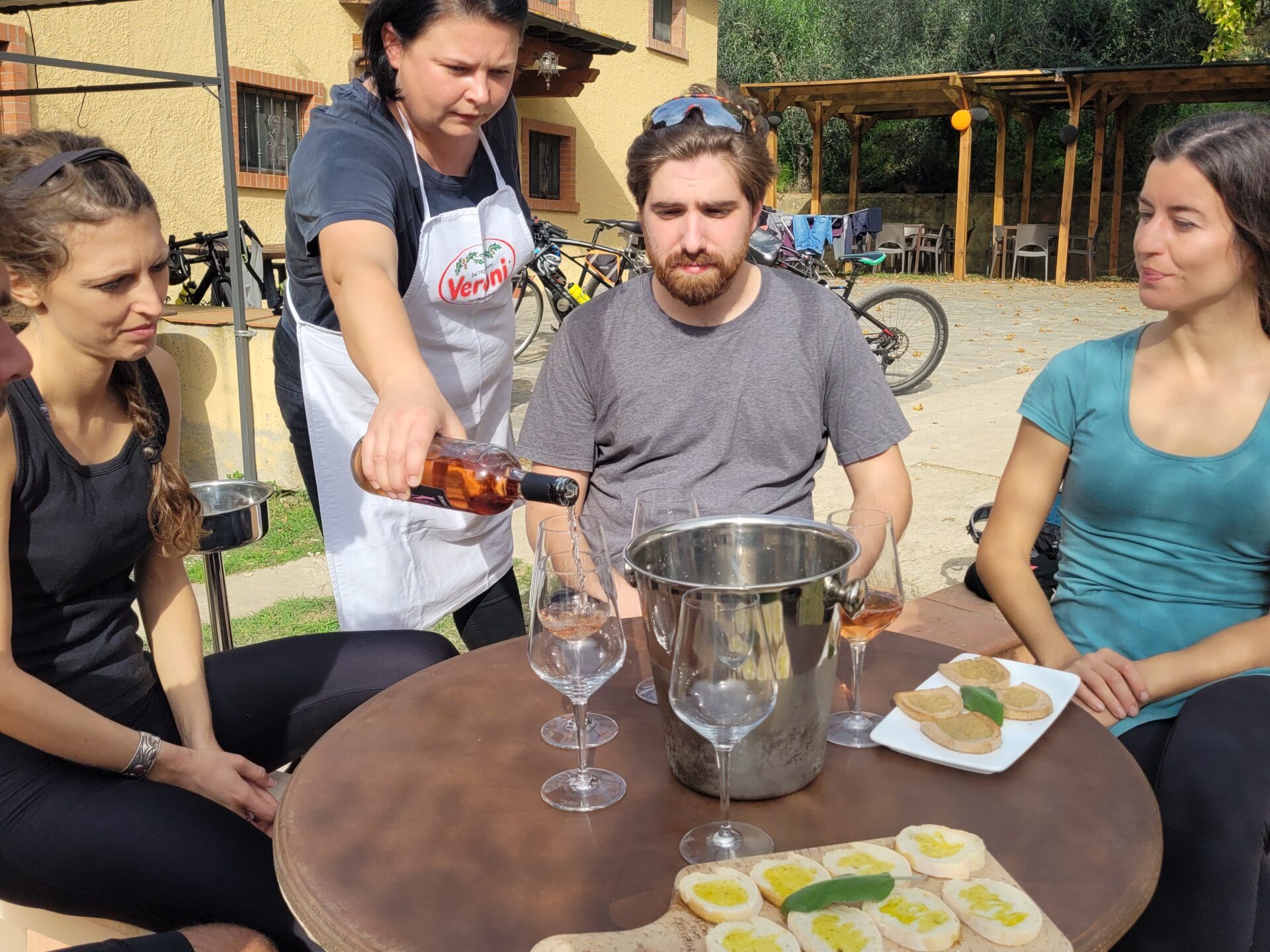 a group of people sitting at a table with food