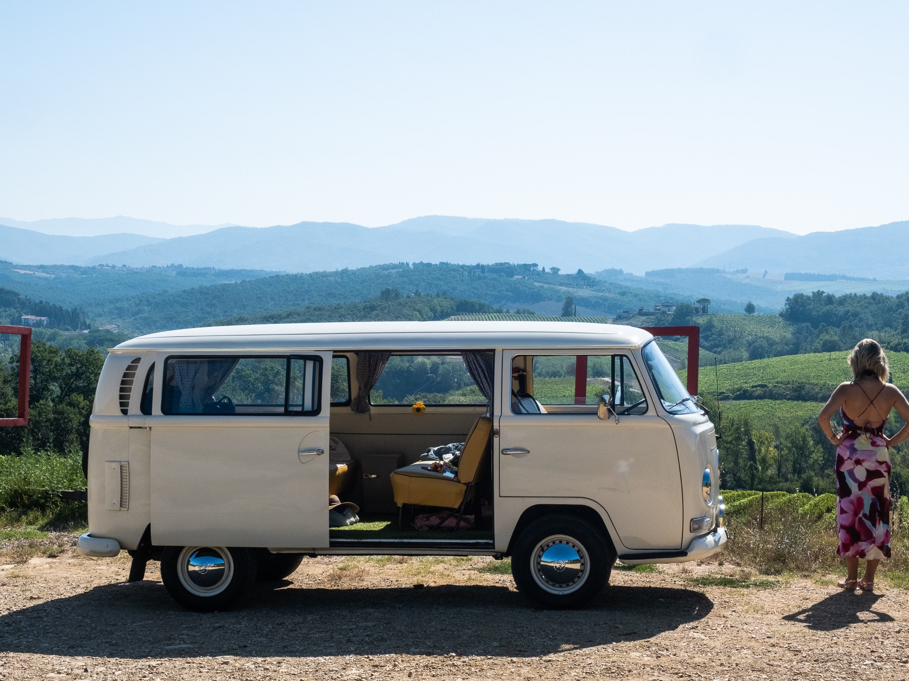 a group of people standing in front of a car