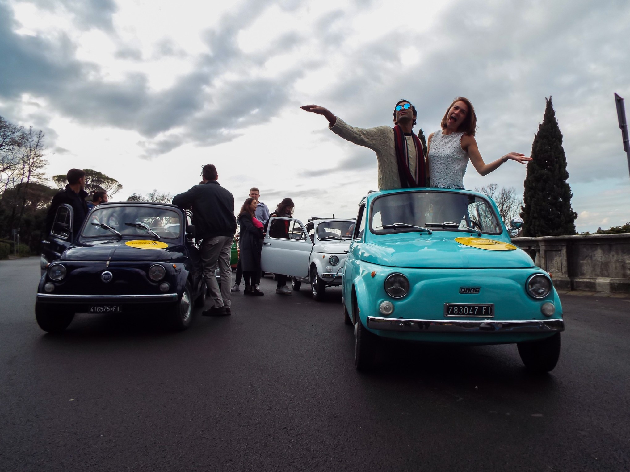 a group of people riding on the back of a car