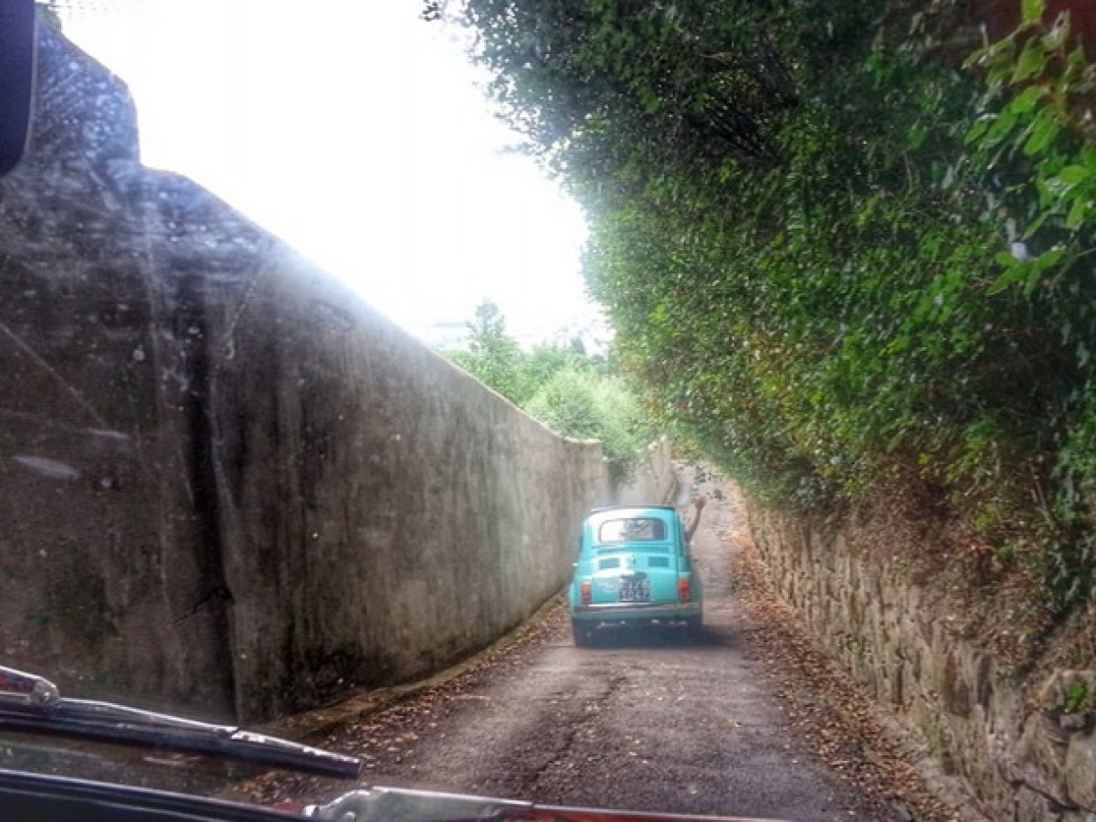 a man driving a car on a train track