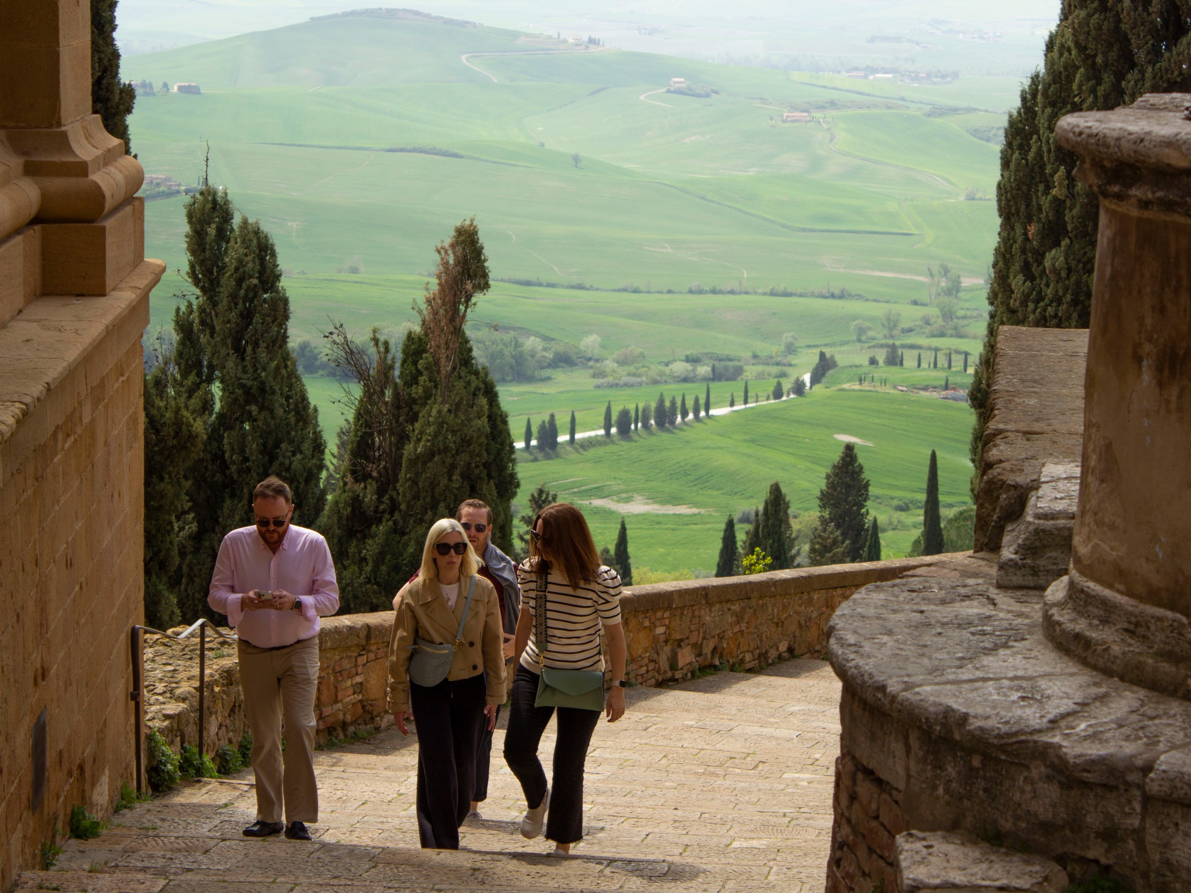 a person standing in front of a stone building