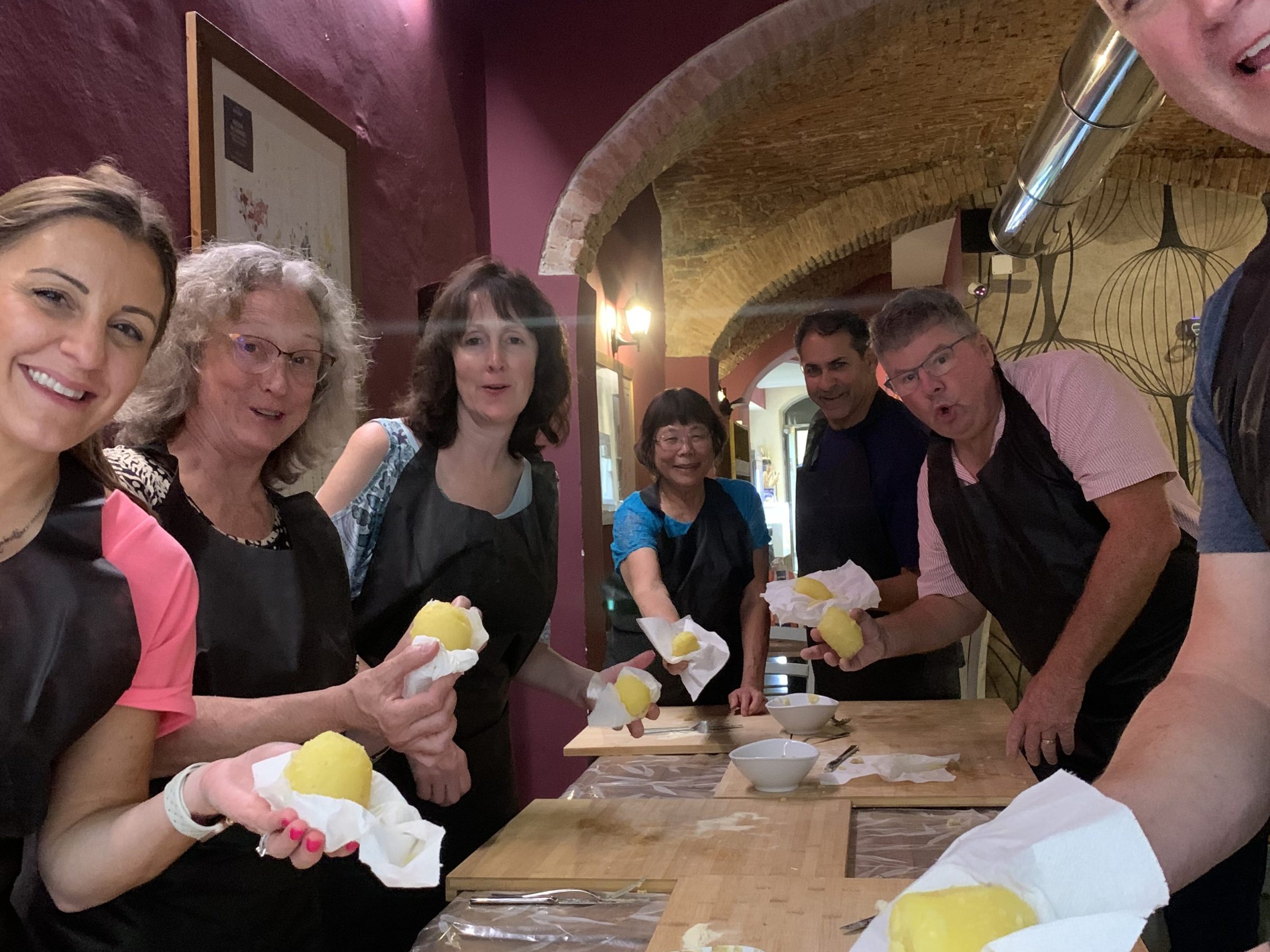 a group of people sitting at a table with a cake